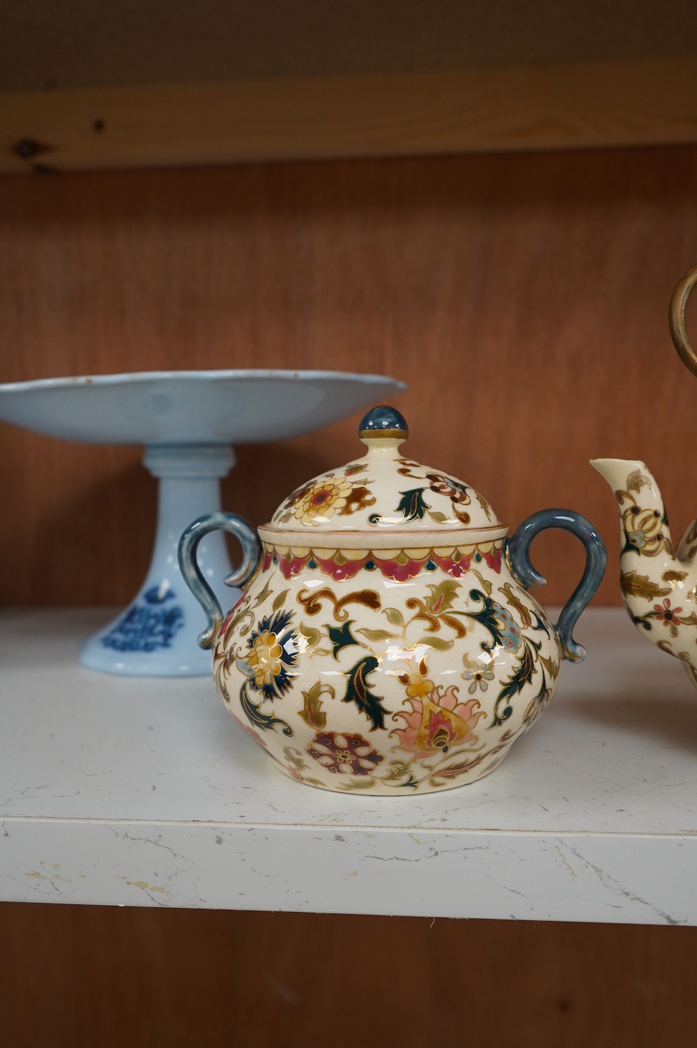 A matched Hungarian Zsolnay floral three piece tea set, largest 17cm high. Condition - fair, crazing throughout